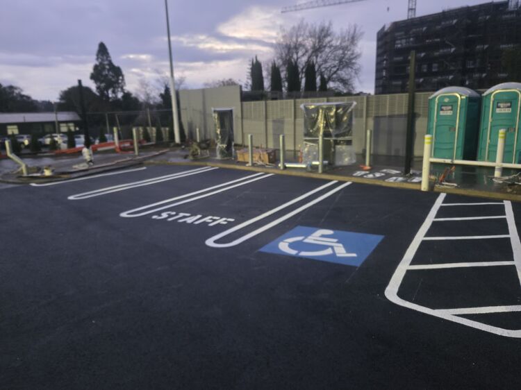Freshly painted staff and accessible parking spaces with clear white line markings by Accurate Linemarking.