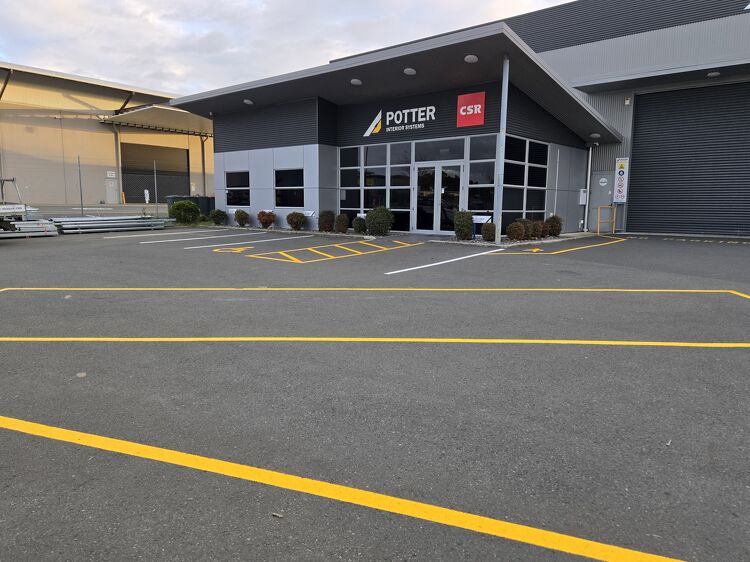 Commercial car park with new yellow line markings outside Potter Interior Systems.