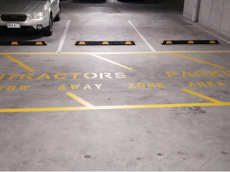 Contractors&rsquo; parking area with clear yellow safety markings and tow-away zone text.