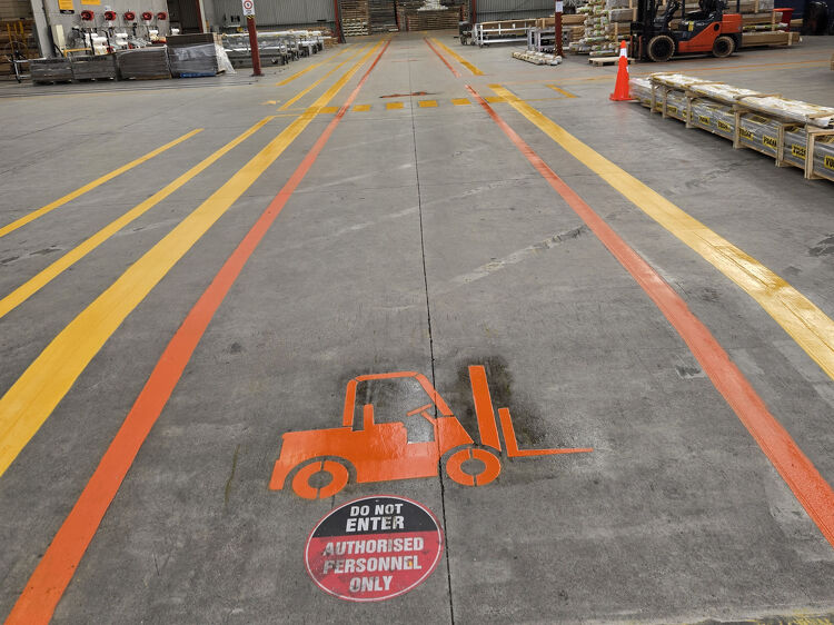 Warehouse forklift lane markings with safety signage for authorised personnel only.